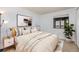 Cozy bedroom with a comfortable bed, a window, neutral colored decor, and stylish lighting at 4681 S Decatur St # 327, Englewood, CO 80110