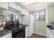Practical kitchen with white cabinets, black oven range, tile floors, and a view to the outside at 4681 S Decatur St # 327, Englewood, CO 80110