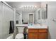 A cozy full bathroom with glass-door shower, mirror, toilet, and single-sink vanity at 2427 Cherry Cir, Brighton, CO 80601