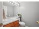 Half bath features a wood cabinet sink, neutral color scheme, and modern fixtures at 2427 Cherry Cir, Brighton, CO 80601
