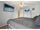 A bedroom with two large flat-screen TVs, light blue walls, and access to the stairway at 2427 Cherry Cir, Brighton, CO 80601