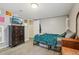 Bedroom features a bed, dresser, TV, and access to the doorway at 2427 Cherry Cir, Brighton, CO 80601