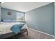 Bright bedroom with light blue walls, large window, and comfortable bed at 2427 Cherry Cir, Brighton, CO 80601