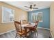 Charming dining area with ample natural light, stylish ceiling fan, and neutral decor at 2427 Cherry Cir, Brighton, CO 80601