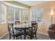 Cozy dining room with natural light, wood floors, and a classic dining set perfect for Gathering meals at 2427 Cherry Cir, Brighton, CO 80601