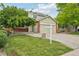 Charming two-story home with a green exterior, red brick accents, and a well-manicured lawn at 2427 Cherry Cir, Brighton, CO 80601