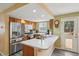 Modern kitchen featuring stainless steel appliances, ample counter space, and a convenient breakfast bar at 2427 Cherry Cir, Brighton, CO 80601