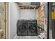 Modern laundry room featuring a gray washer and dryer, plus updated water heater at 2427 Cherry Cir, Brighton, CO 80601
