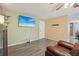 Inviting living room featuring stylish vinyl plank flooring and a large-screen TV at 2427 Cherry Cir, Brighton, CO 80601