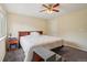 Neutral main bedroom featuring ceiling fan, large bed, and built in headboard at 2427 Cherry Cir, Brighton, CO 80601