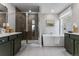 Elegant bathroom featuring a glass-enclosed shower, soaking tub, and dual vanities, creating a spa-like atmosphere at 4334 Ridgewalk Pt, Castle Rock, CO 80108