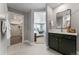 Bathroom view with walk-in closet and bedroom in the background, showcasing the en-suite layout and modern finishes at 4334 Ridgewalk Pt, Castle Rock, CO 80108