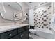 Well-designed bathroom with modern fixtures, black vanity, and tiled shower with cloud-shaped shelves at 4334 Ridgewalk Pt, Castle Rock, CO 80108