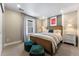 Bright bedroom with a stylish bed, cozy seating, soft carpet, and a coordinating color scheme at 4334 Ridgewalk Pt, Castle Rock, CO 80108