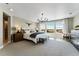 Spacious main bedroom with large windows, stylish chandelier, and comfortable seating, offering a serene retreat at 4334 Ridgewalk Pt, Castle Rock, CO 80108