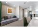 Spacious hallway lounge area with stylish sofa, textured wall, and ample lighting, perfect for relaxation at 4334 Ridgewalk Pt, Castle Rock, CO 80108