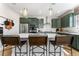 Close up of a modern kitchen with white countertops, stainless appliances and barstool seating at 4334 Ridgewalk Pt, Castle Rock, CO 80108