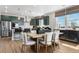 Stylish eat-in kitchen and dining area with barstool seating and lots of natural light at 4334 Ridgewalk Pt, Castle Rock, CO 80108
