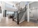 Open-concept living area featuring high ceilings, large windows, and an elegant staircase at 4334 Ridgewalk Pt, Castle Rock, CO 80108