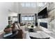 Bright living room featuring a high ceiling, fireplace, and lots of natural light at 4334 Ridgewalk Pt, Castle Rock, CO 80108
