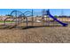 Community playground with climbing structures, a slide, and soft wood chip ground cover at 4334 Ridgewalk Pt, Castle Rock, CO 80108