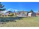 View of the home's backyard with a small deck and storage shed at 7120 Utica St, Westminster, CO 80030