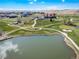Scenic aerial view overlooking the golf course, community, pond, and clubhouse at 42400 Forest Oaks Dr, Elizabeth, CO 80107