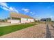 Expansive backyard showcases a well-kept lawn, rock ground cover, and a privacy fence at 42400 Forest Oaks Dr, Elizabeth, CO 80107