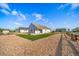 Landscaped backyard featuring a well-maintained lawn, rock ground cover, and a charming wooden fence at 42400 Forest Oaks Dr, Elizabeth, CO 80107