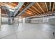 Unfinished basement featuring concrete floors, exposed beams, and natural light at 42400 Forest Oaks Dr, Elizabeth, CO 80107