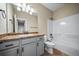 This bathroom features a vanity with grey cabinets, and a shower-tub combination at 42400 Forest Oaks Dr, Elizabeth, CO 80107