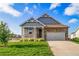 Charming home showcasing a stone facade, two-car garage, covered porch and manicured lawn on a bright day at 42400 Forest Oaks Dr, Elizabeth, CO 80107