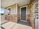 Inviting front porch featuring stone accents and a stylish entrance door at 42400 Forest Oaks Dr, Elizabeth, CO 80107