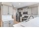 Bright kitchen features stainless steel appliances, light gray cabinets, subway tile backsplash, and quartz countertops at 42400 Forest Oaks Dr, Elizabeth, CO 80107