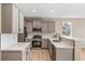 Charming kitchen showcases stainless steel appliances, light gray cabinets, subway tile backsplash, and luxury vinyl flooring at 42400 Forest Oaks Dr, Elizabeth, CO 80107