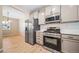 Renovated kitchen features stainless steel appliances, gray cabinets, and modern finishes adjacent to dining room at 42400 Forest Oaks Dr, Elizabeth, CO 80107