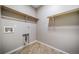 This functional laundry room provides storage shelves, tile flooring, and utility connections at 42400 Forest Oaks Dr, Elizabeth, CO 80107