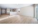 Bright living room with hardwood floors and an open layout connecting to the kitchen at 42400 Forest Oaks Dr, Elizabeth, CO 80107