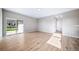 Open living space featuring wood floors, a sliding door to the backyard, and neutral wall paint at 42400 Forest Oaks Dr, Elizabeth, CO 80107