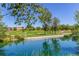 Scenic pond reflecting trees and sky, enhancing community's natural beauty near playground at 2927 W 81St Ave # H, Westminster, CO 80031