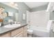 Well-lit bathroom featuring a shower-tub, with stylish vanity and decor at 12070 E Arizona Ave, Aurora, CO 80012