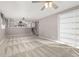 Spacious living room featuring stairs to the upper floor, built-in shelving, and plush carpet at 12070 E Arizona Ave, Aurora, CO 80012