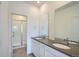 Bathroom featuring a double sink vanity with modern fixtures and a glass-enclosed shower stall at 14578 W 90Th Ln # B, Arvada, CO 80005