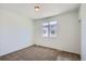 Cozy bedroom featuring neutral carpet, white walls, and a window providing natural light at 14578 W 90Th Ln # B, Arvada, CO 80005