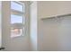 A bright walk-in closet with shelving, and a view of the street through the high window at 14578 W 90Th Ln # B, Arvada, CO 80005