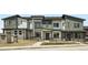 Modern townhomes with stone and siding exteriors, and welcoming front porches create charming curb appeal at 14578 W 90Th Ln # B, Arvada, CO 80005