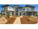 Modern townhome exteriors with stylish gray and white facade, stone accents, and landscaped front yards at 14578 W 90Th Ln # B, Arvada, CO 80005