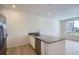 Bright kitchen with a center island, modern appliances, and large windows offering natural light at 14578 W 90Th Ln # B, Arvada, CO 80005