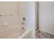 Clean bathroom features a white tiled tub and shower combination with glass door at 11250 Florence St # 20B, Commerce City, CO 80640