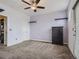 Neutral bedroom featuring a ceiling fan, neutral carpet, and a sleek black dresser at 11250 Florence St # 20B, Commerce City, CO 80640